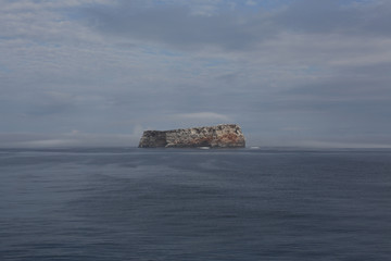 Fototapeta na wymiar ship and island in the fog, Galapagos, Pacific Ocean
