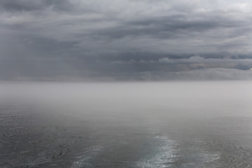 ship and island in the fog, Galapagos, Pacific Ocean