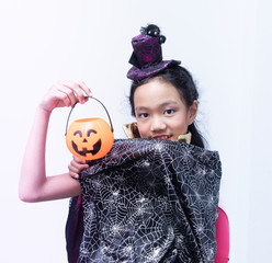 Girl with halloween costumes on white background.