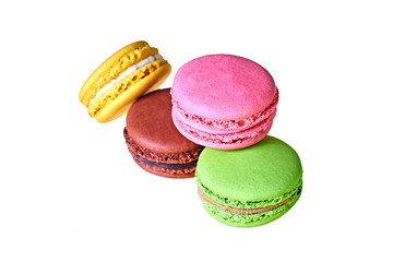 Heap of macaroons with different colors and varied taste, lemon, almond, chocolate, raspberry, strawberry and mint isolated on white background. Close-up