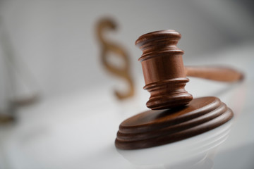 Judge antique gavel and scale - law and justice symbols on white table and background.