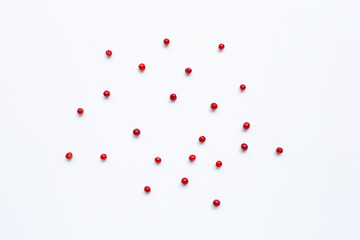 Red peppercorns  on white