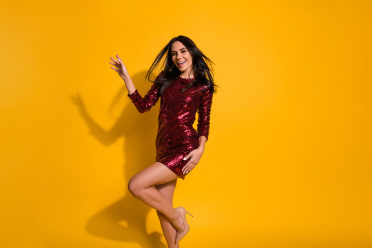 Dancing queen. Profile photo of amazing lady with perfect slim shapes dancing like celebrity wear short shine red dress isolated yellow color background
