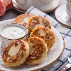 Curd pancakes with strawberry sauce on a plate