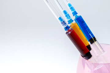 A set of medical syringes with color injections for cosmetology. The cocktail of the beautician for...