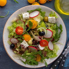 Diet salad with vegetables, lettuce, arugula and cheese. Healthy food. Top view.