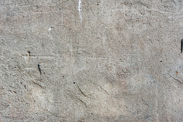 Texture of a concrete wall with cracks and scratches which can be used as a background