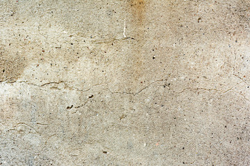Texture of a concrete wall with cracks and scratches which can be used as a background