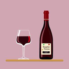 Beaujolais Nouveau. Bottle and wine glass with Beaujolais Nouveau isolated on pink background