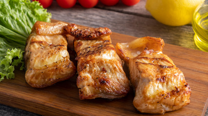Grilled sturgeon with vegetables on wooden board.  Diet and healthy food