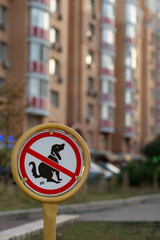 No pooping or shitting dogs no peeing dogs sign. Prohibition sign against the background of apartment buildings. Shitting is not allowed at public area. No dogs excrement