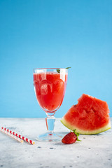 Watermelon juice in glass with strawberry on top