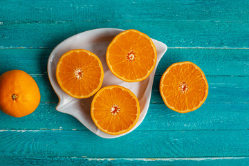 Natural and fresh half cut oranges on plate