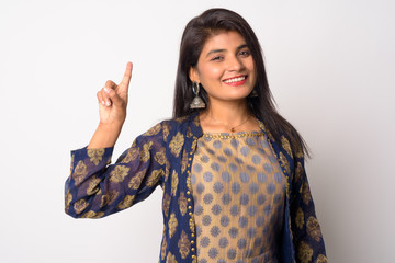 Happy young Persian woman pointing up in traditional clothing
