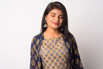 Face of young beautiful Persian woman relaxing with eyes closed in traditional clothing