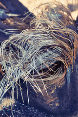 burnt tires. melted old rubber. metal rods stick out of the wheel.