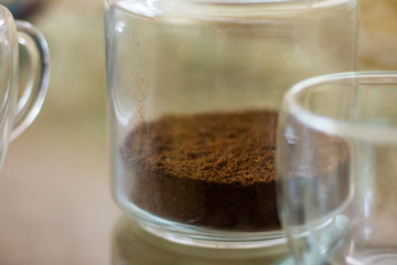 Ground coffee in a jar. Dry coffee in a jar on the table. Not brewed coffee. copy space