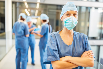 Woman as a surgeon in front of doctors team in clinic