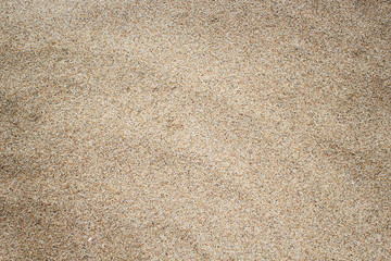 Fine sand texture. Brown sand background. Top view