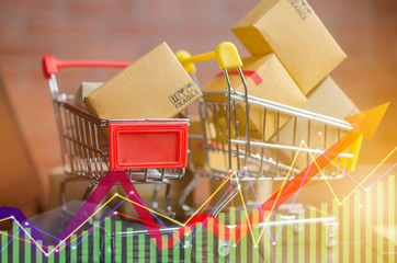 Many boxes in a trolley on a laptop keyboard,on brick background. Ideas online shopping is a form...