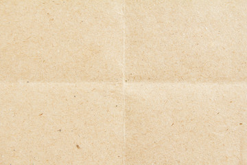 Brown beige sheet of craft cardboard paper folded in four.