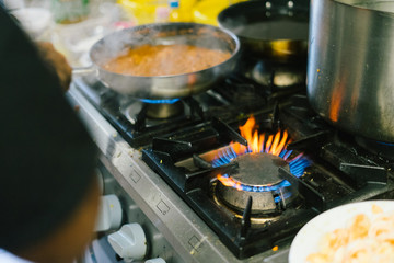 close up gas stove with blue flames
