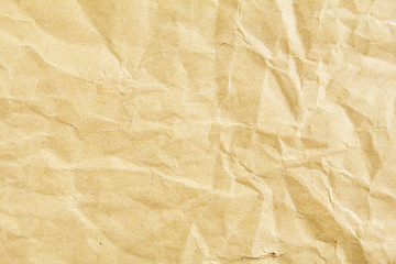 Closeup crumpled brown beige sheet of craft wrapping paper texture background. - obrazy, fototapety, plakaty