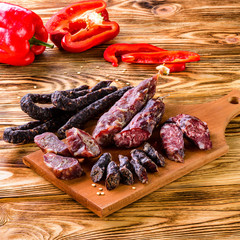 Grilled sausages with vegetables close up on an old table