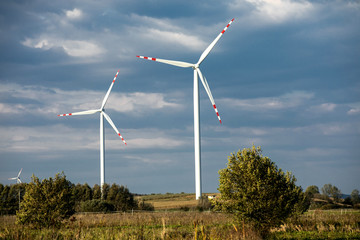 Wind turbines on green hills, Group of windmills for electric power production in the green