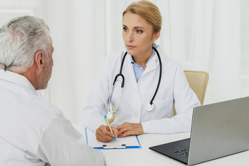 Doctor taking notes with patient