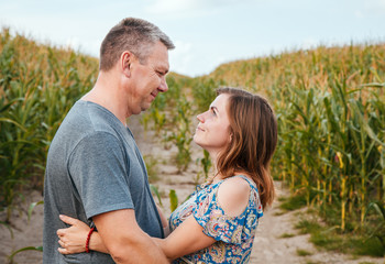 couple in love cuddling in a corn field