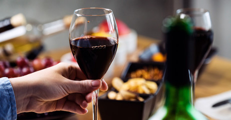 Pouring wine into glass and food background
