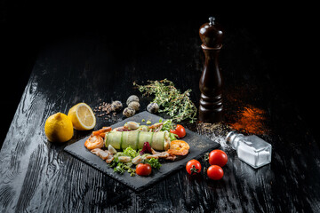 Plate with appetizers, shrimp, cucumber, eggs, salad.