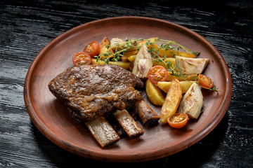 Ethically raised, fresh cut organic rib eye steak grilled with fried potatoes.
