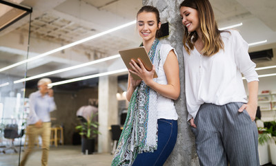 Team of colleagues brainstorming together while working in modern office