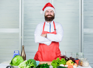 Last minute christmas dinner idea. Cooking delicious and quick holiday meal. Simple recipe with little active cooking time. Man santa hat bearded hipster wear culinary apron. Cooking dish for family