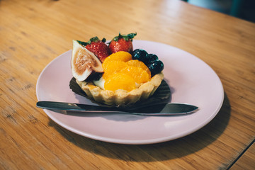 Close up of fruit tart on the wooden table.