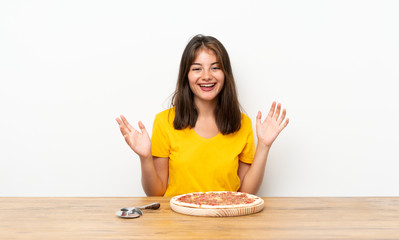 Caucasian girl with a pizza laughing