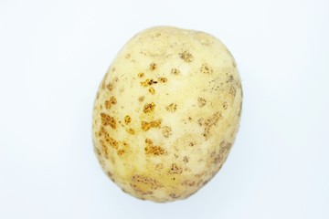 Raw unpeeled potatoes located on a white background