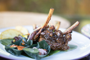 Grilled pork ribs with Indonesian style sauce on the plate. Indonesian cuisine.