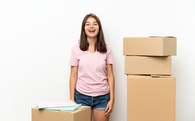 Young girl moving in new home among boxes with surprise facial expression
