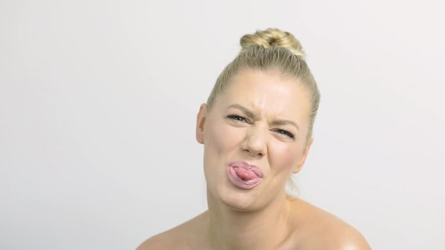 Fun-loving female model sticks her tongue out at the camera.