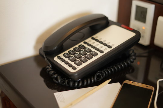 Classic table phone in hotel room
