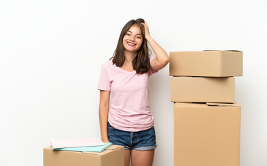 Young girl moving in new home among boxes having doubts with confuse face expression