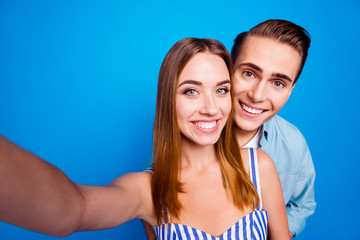 Self-portrait of her she his he two nice attractive lovely sweet tender adorable cheerful cheery partners hugging traveling isolated over bright vivid shine vibrant blue color background