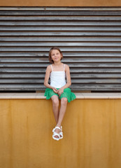 Portrait of a little girl in an urban, with a geometric background. Photo taken with  smartphone. Outdoor lifestyle portrait .