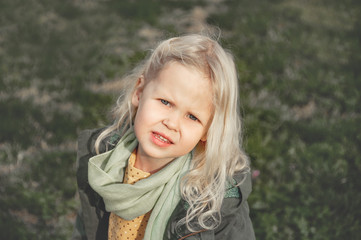 Fototapeta premium Sweet little girl outdoors with blonde hair.