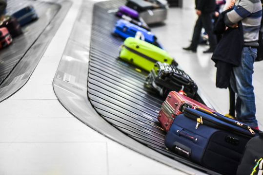 Suit case conveyor belt at airport baggage to claim.