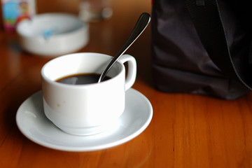 Warm morning coffee in white small cup