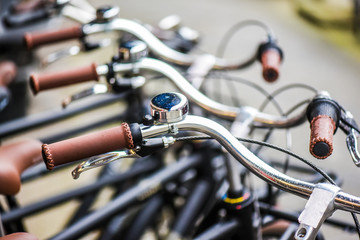 Fototapeta na wymiar Bicycle parking in row. Denmark new modern bike handle and bell.